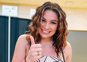 Texas A&M University student wearing an Aggie Ring giving the thumbs up sign with her hand.