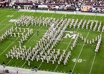 Texas A&M marching band in the formation of ATM on football field.